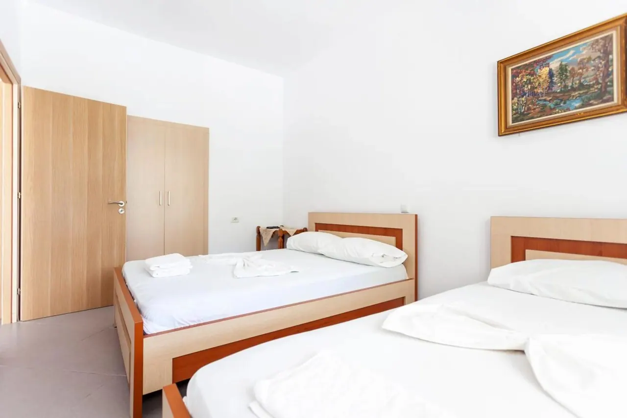 Twin-bedded room with wooden bedsteads and a bright window